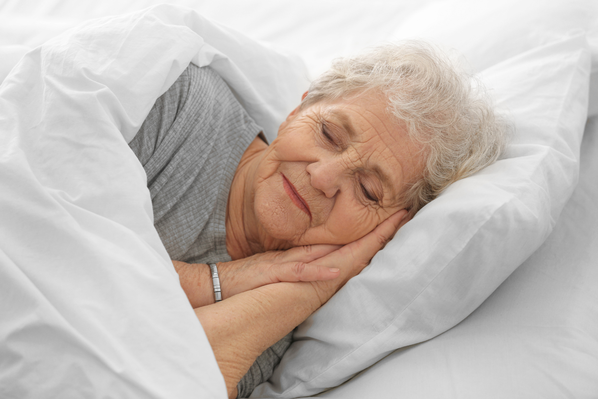 Senior woman peacefully sleeping, addressing sleep problems in seniors, Milton, WI